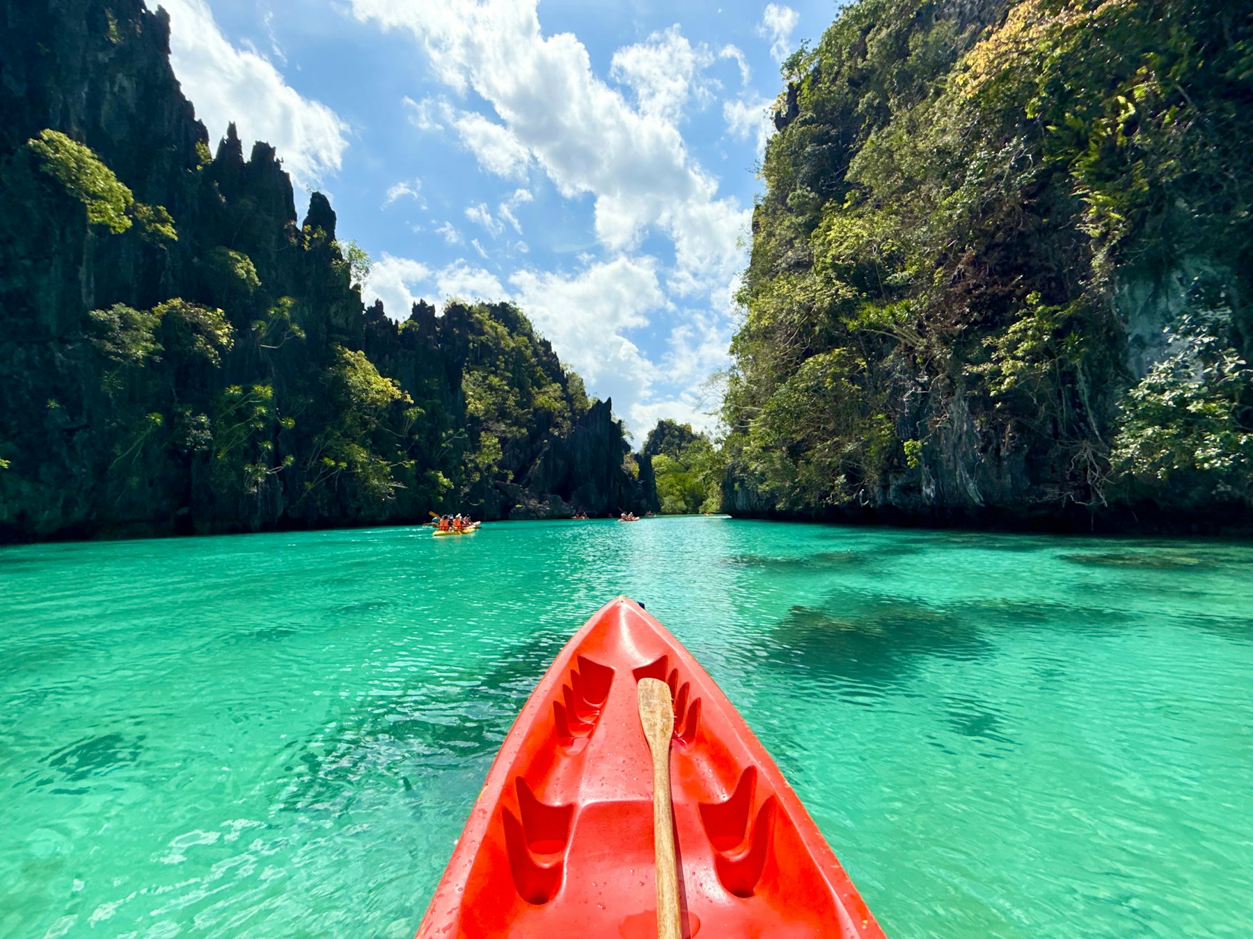 Kayaks under Coron’s limestone walls